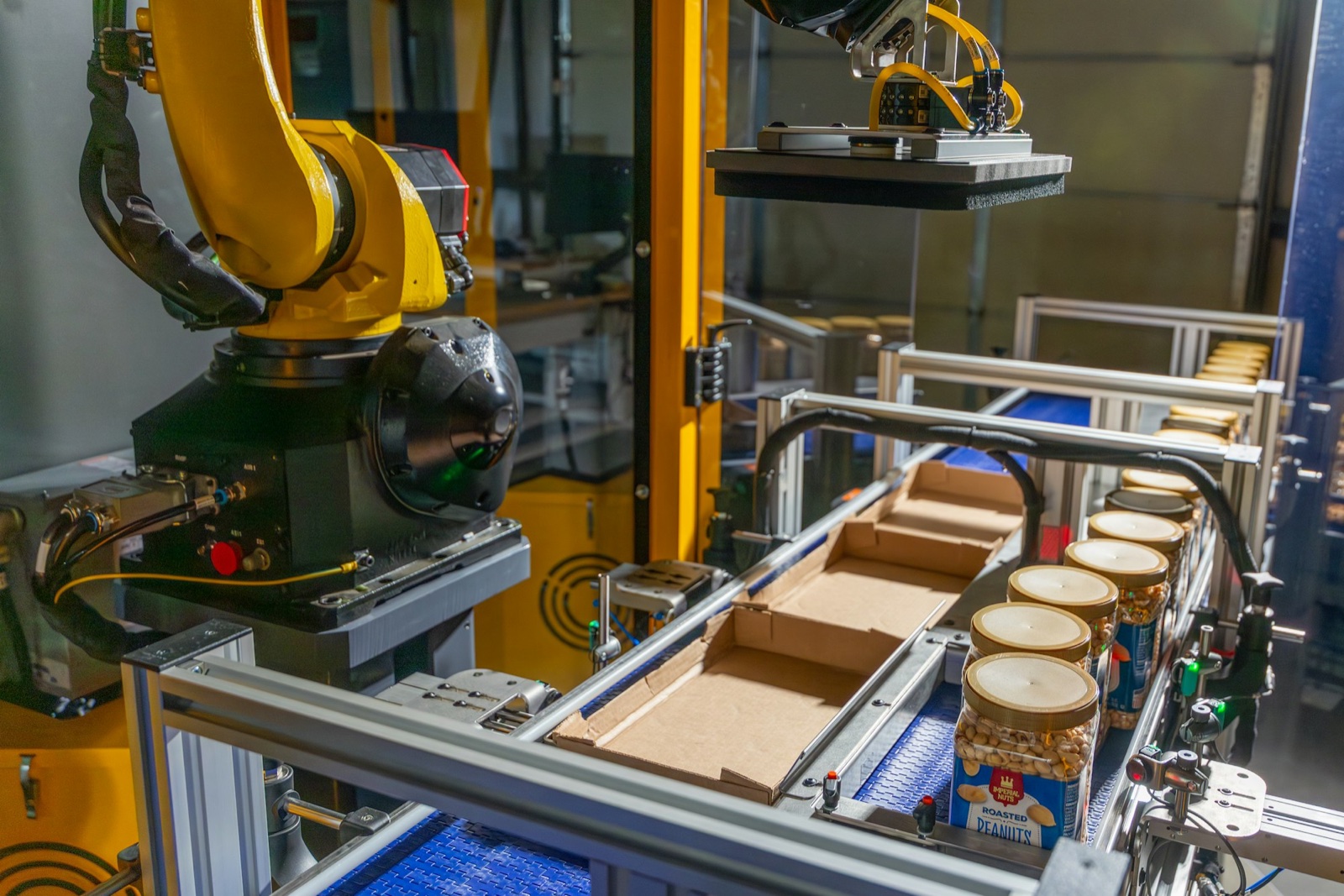 Formic robotic case packer placing jars into a case on a customer production line