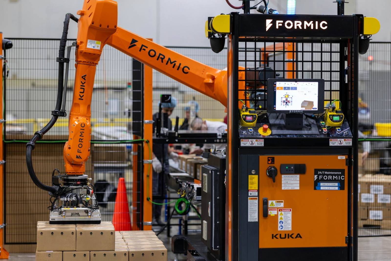 Formic F50 industrial palletizer running on a customer line | Formic-branded KUKA arm with operator station