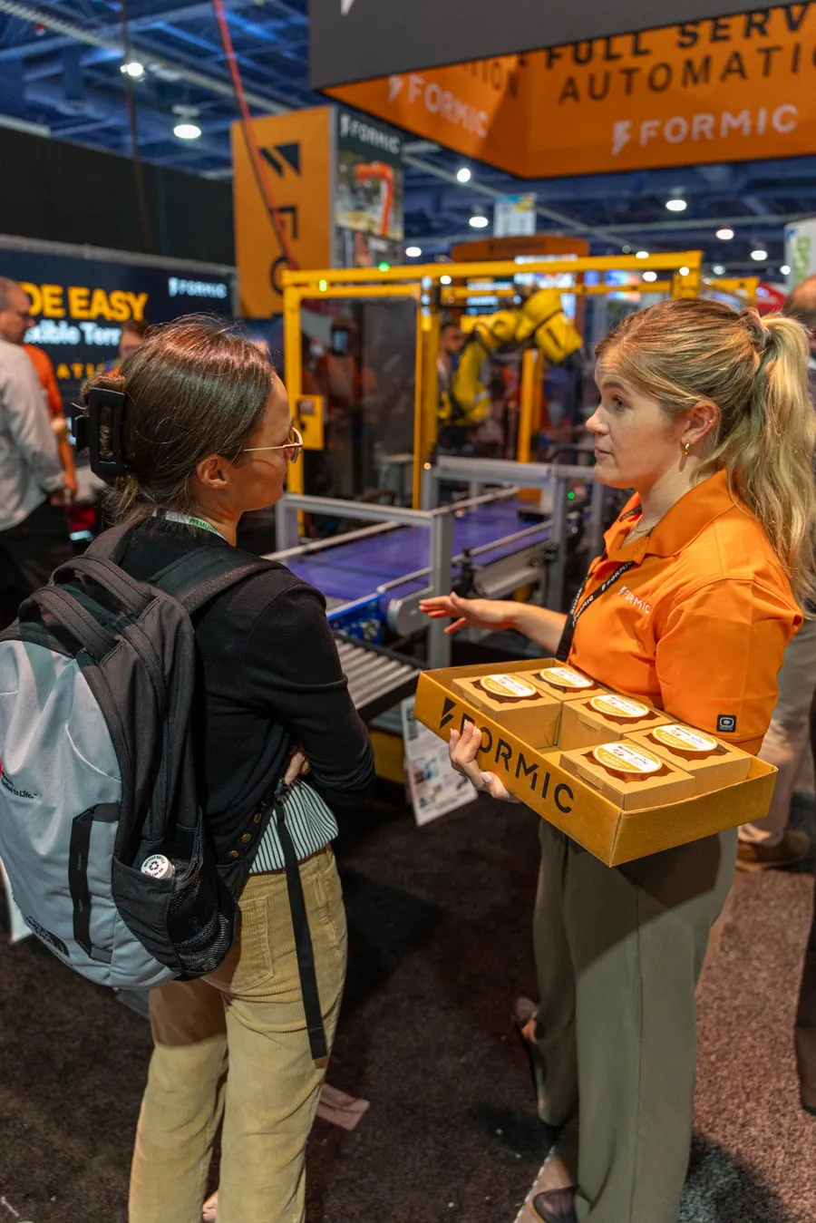 A Formic team member handing out snacks at the booth
