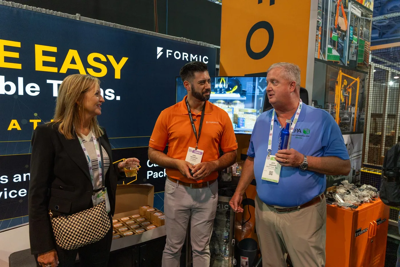 Guests talking over drinks at the Formic booth during last year’s happy hour