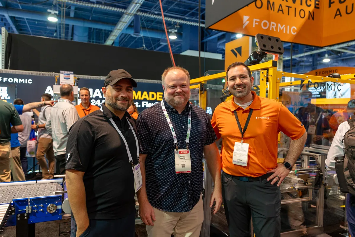Three guests together at the Formic booth