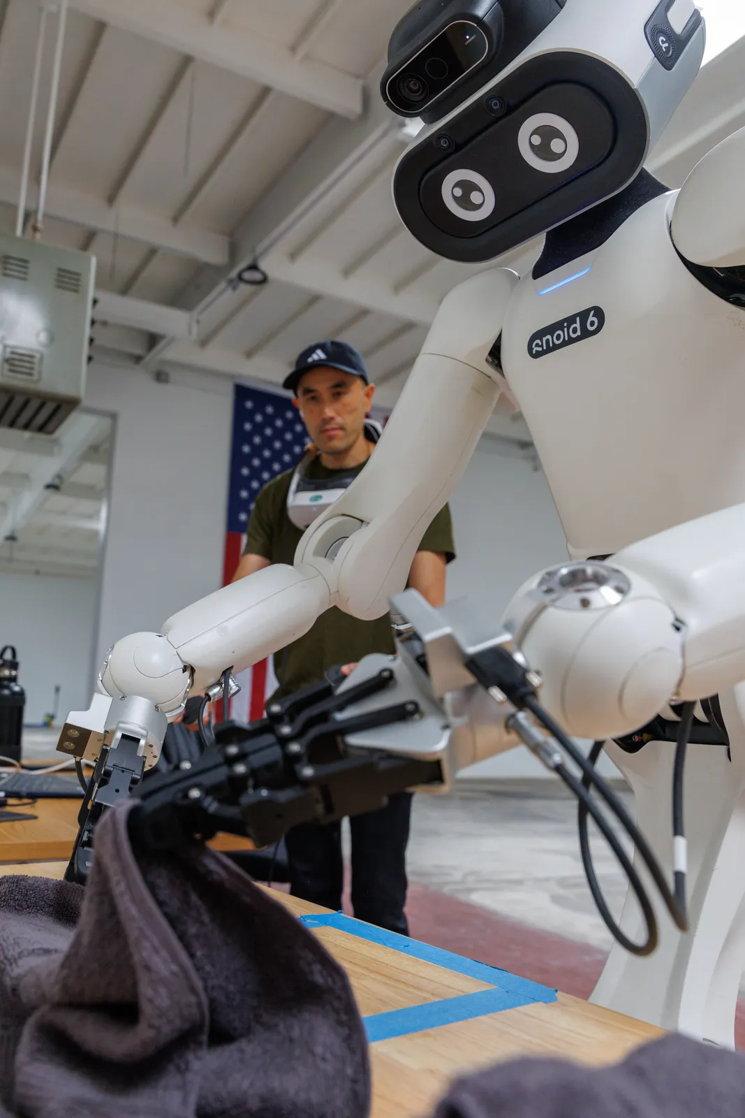 Close-up of a dexterous humanoid robot mid-task at Formic's Oakland lab