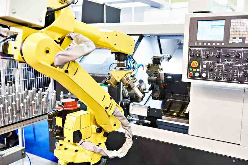 Formic Waybo machine-tending cell loading a CNC machine on a precision floor